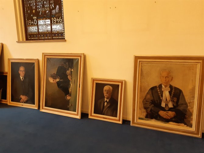 The portraits were carefully placed on the floor