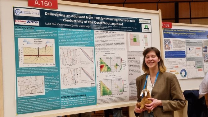 Luka standing next to her work on thermal profiling in the field of hydrogeology