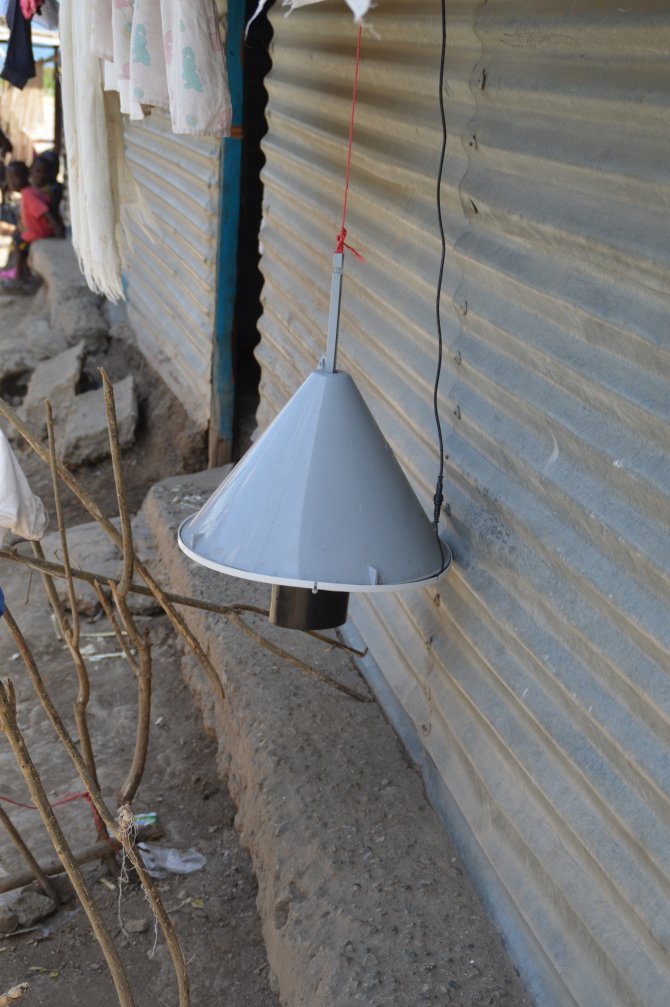 Odour baited trap near a house