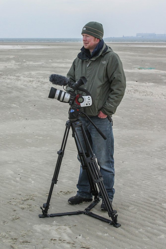Scottish filmmaker Raymond Besant filming on the beach of Texel, the Netherlands.