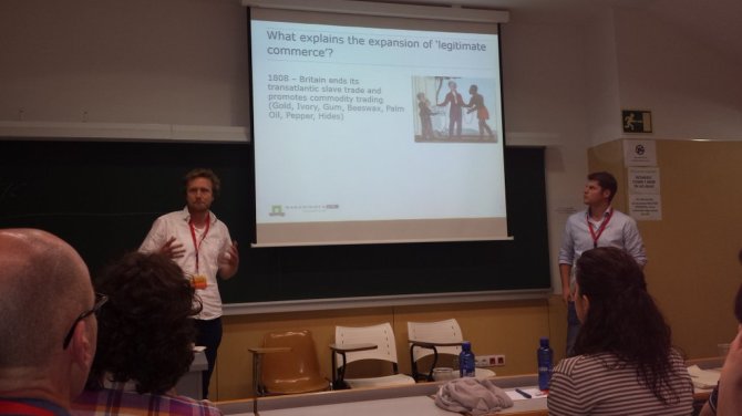 Angus Dalrymple-Smith (left) and Pieter “Jop” Woltjer (right) presenting their work on the expansion of “legitimate commerce”