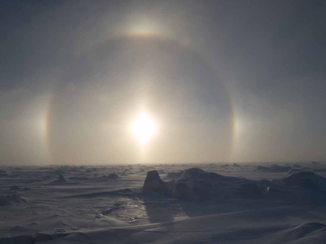 Full halo with clear sun dogs and light pillar. 