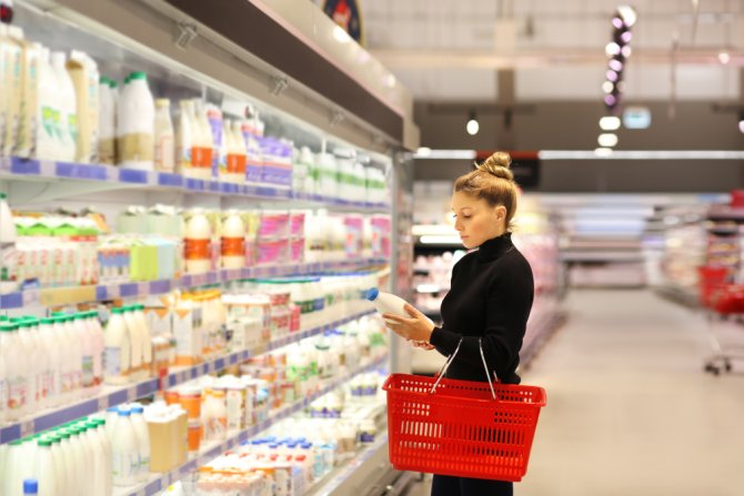 Customer choosing between dairy products