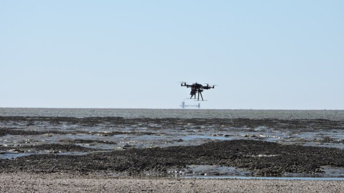Octocopter of Unmanned Aerial Remote Sensing Facility flying over mussel bank in Waddensea with Hyperspectral Mapping System (HyMSy)