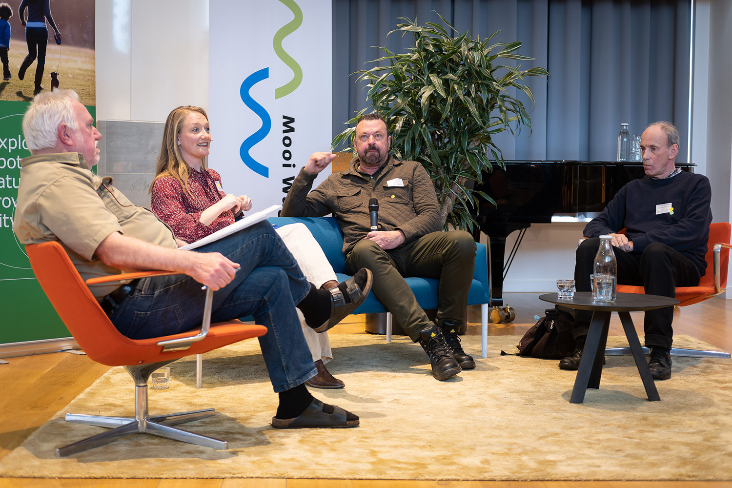 Vlnr. Henk Baptist, Simone Ritzer (dagvoorzitter), Jaap Dirkmaat, Wim van Opbergen.